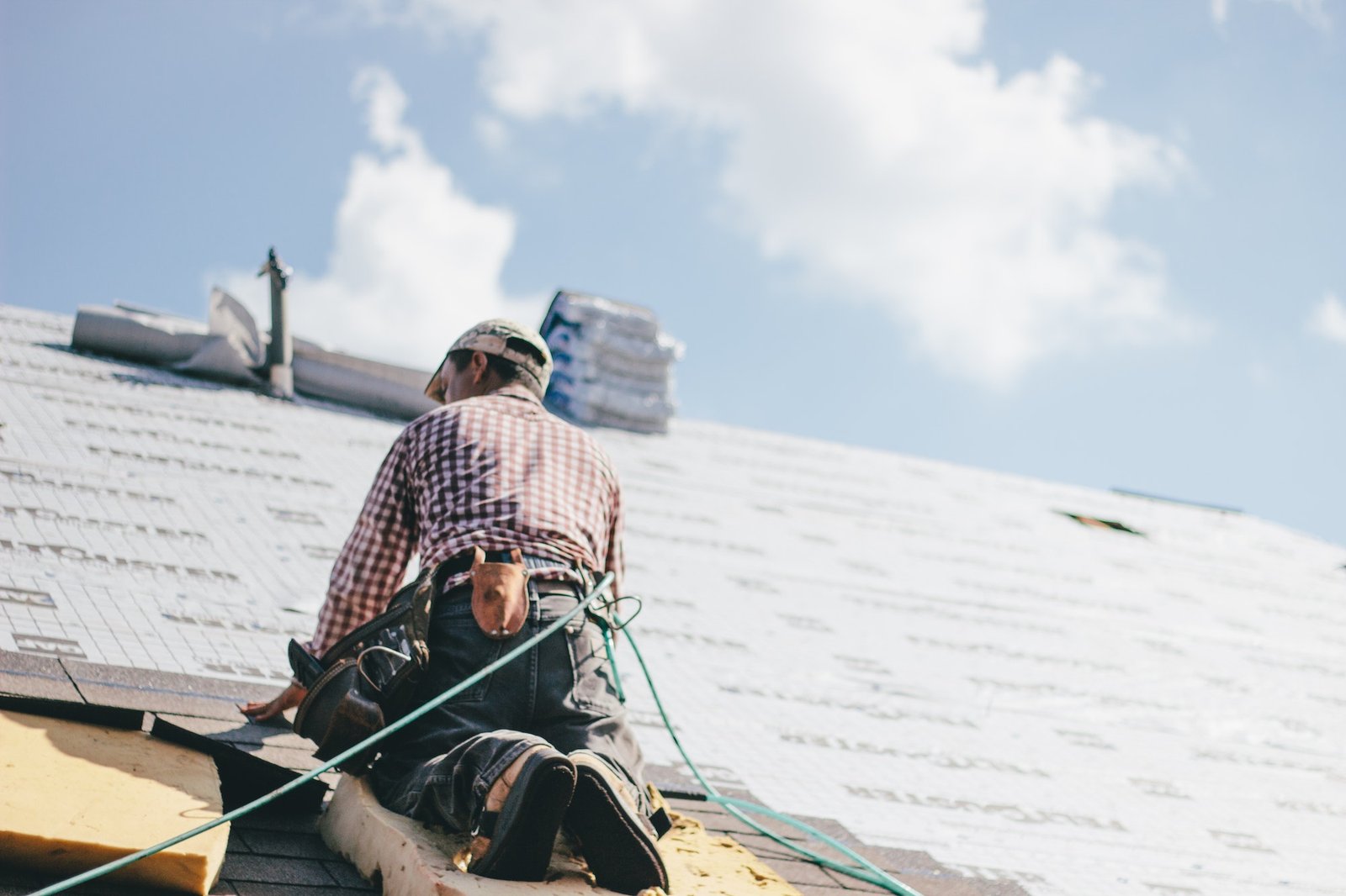 roofer-adding-shingles-to-the-roof-of-a-house